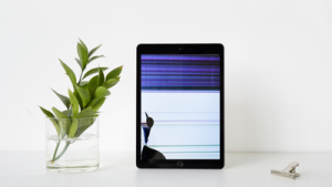 damaged iPad screen with inky spot and lines